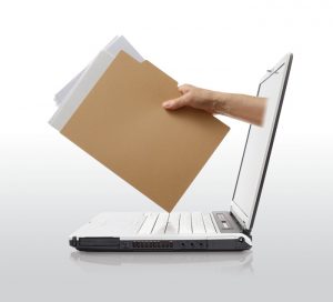 A laptop with an arm sticking out of the screen holding a paper folder